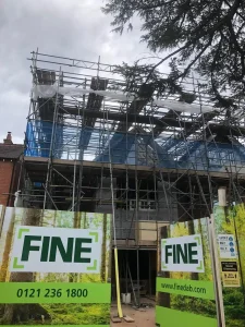 Scaffolding installed around a building with safety netting.